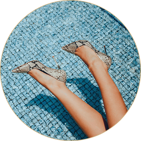 Woman wearing fancy shoes by a pool